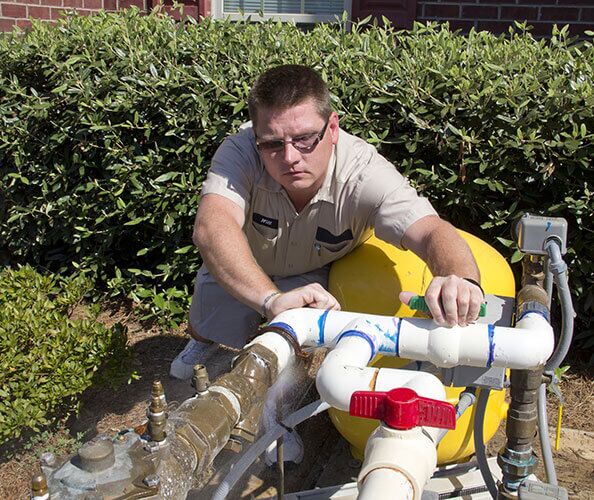 plumber clears backflow device